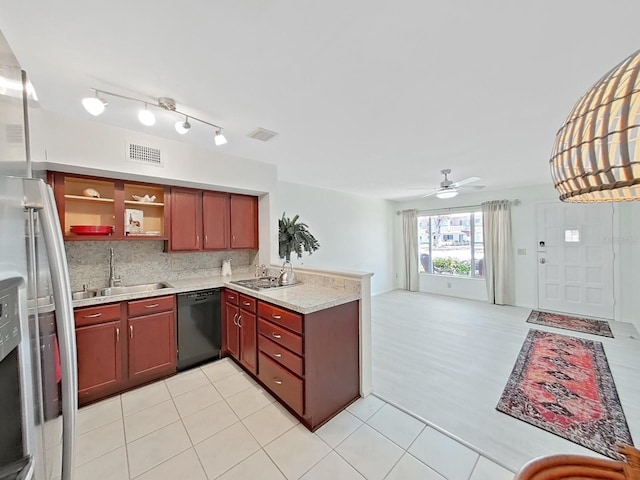 kitchen featuring black dishwasher, a peninsula, a sink, and visible vents