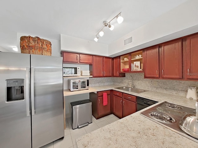 kitchen featuring light tile patterned floors, stainless steel appliances, a sink, visible vents, and backsplash