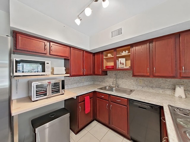 kitchen featuring stainless steel appliances, a sink, visible vents, dark brown cabinets, and light countertops