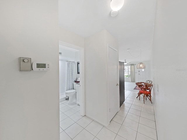 hall featuring light tile patterned floors