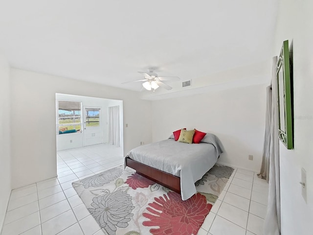 bedroom featuring a ceiling fan, visible vents, and light tile patterned floors