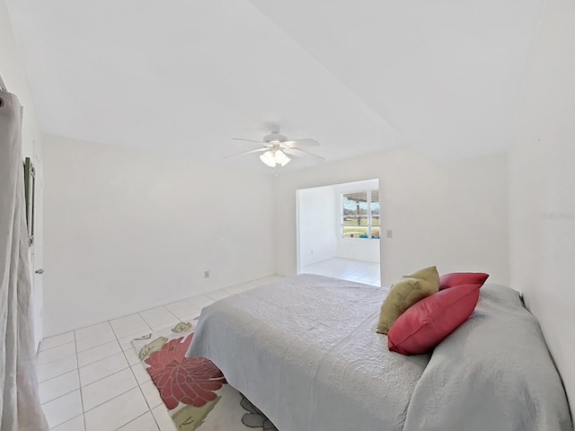 tiled bedroom featuring ceiling fan