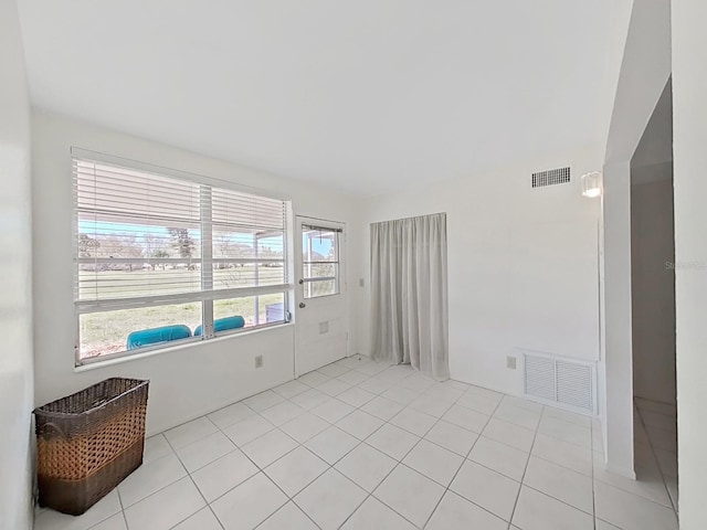 empty room with light tile patterned floors and visible vents