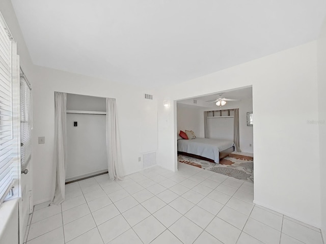 unfurnished bedroom featuring a closet, visible vents, and light tile patterned flooring