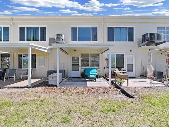 back of house featuring central AC, a patio area, and a balcony