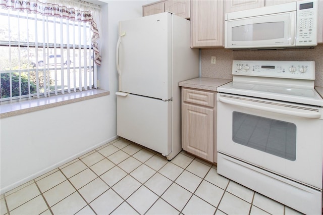 kitchen with white appliances, light countertops, decorative backsplash, and light tile patterned floors