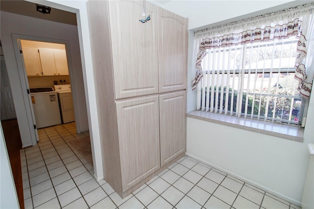 kitchen featuring light tile patterned floors and washing machine and dryer