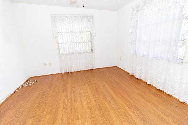 unfurnished room featuring a ceiling fan and wood finished floors