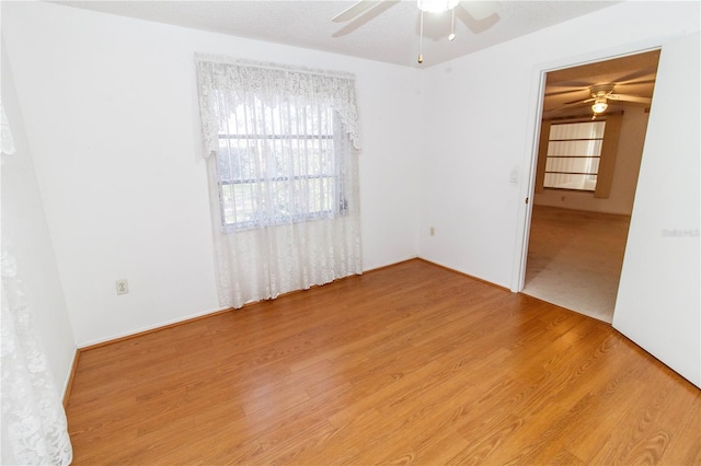 spare room with a ceiling fan and wood finished floors