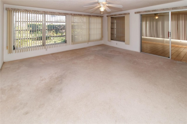 carpeted empty room with ceiling fan