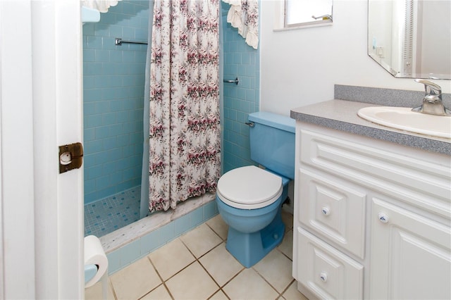 bathroom with a stall shower, vanity, toilet, and tile patterned floors