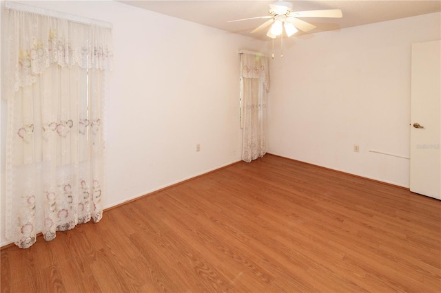 empty room with ceiling fan and wood finished floors