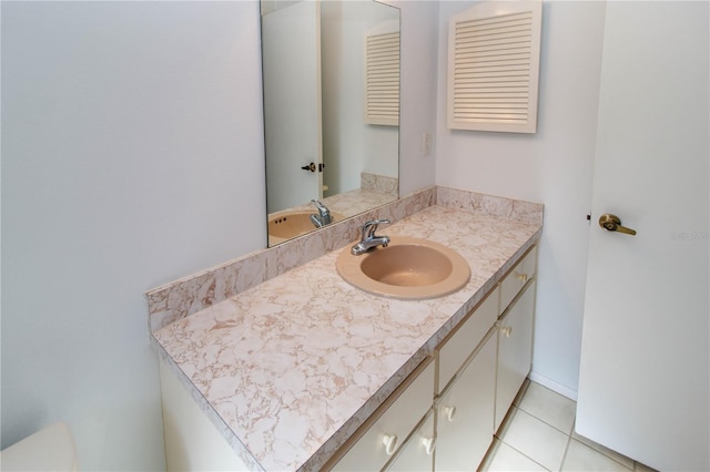 bathroom featuring vanity, toilet, and tile patterned floors