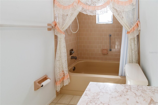 full bathroom featuring tile patterned flooring, toilet, and shower / bath combo