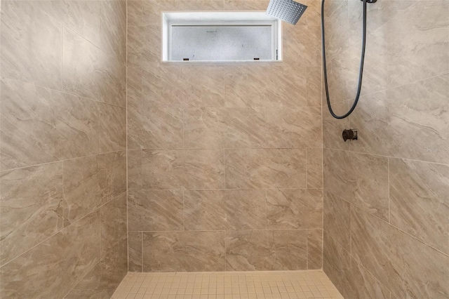 bathroom with tiled shower