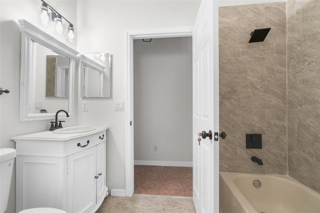 bathroom featuring baseboards, toilet, tile patterned floors, vanity, and shower / washtub combination