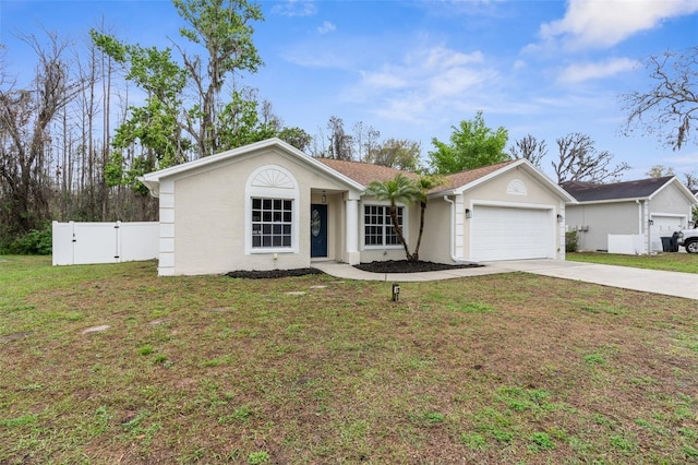 ranch-style home featuring a front lawn, concrete driveway, an attached garage, and a gate