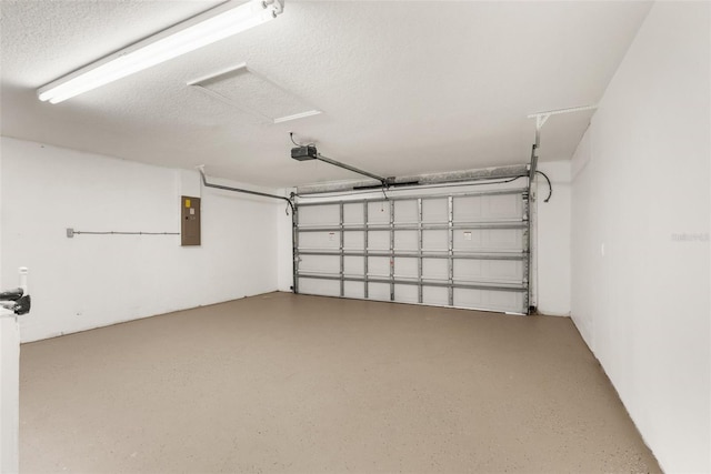 garage with a garage door opener and electric panel