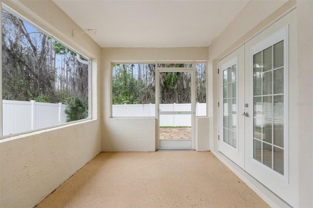 unfurnished sunroom with a wealth of natural light and french doors