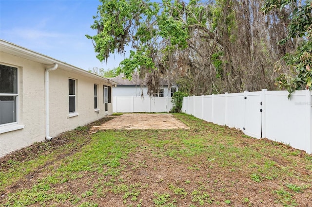 view of yard featuring a patio area and a fenced backyard