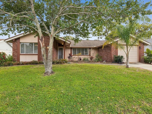 ranch-style house with a front lawn, an attached garage, and driveway