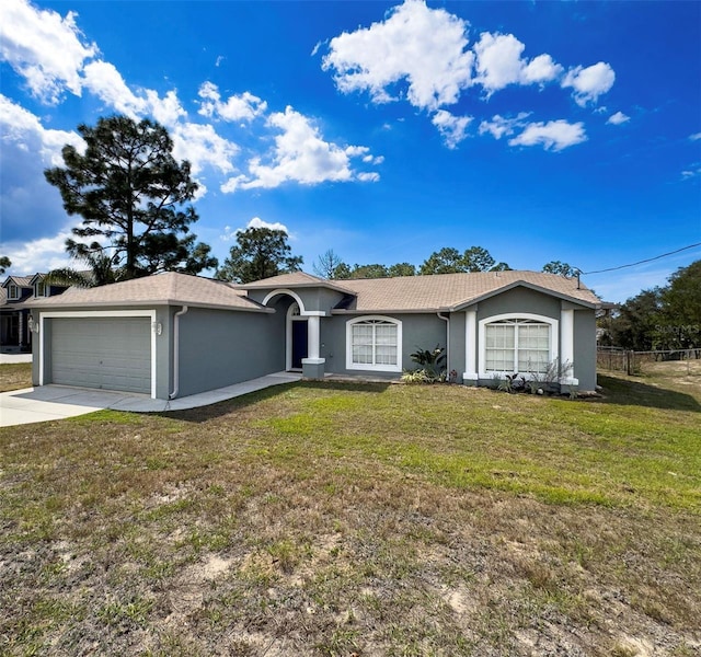 ranch-style home featuring driveway, a garage, fence, a front lawn, and stucco siding