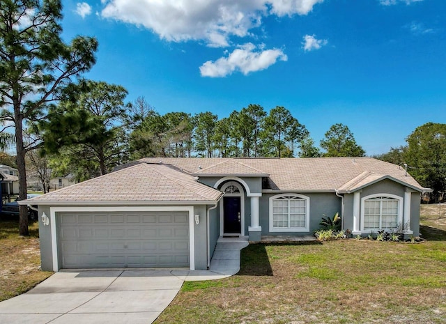 ranch-style home featuring a garage, concrete driveway, a front lawn, and stucco siding