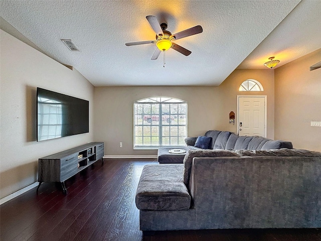 living area with visible vents, hardwood / wood-style floors, a ceiling fan, a textured ceiling, and baseboards