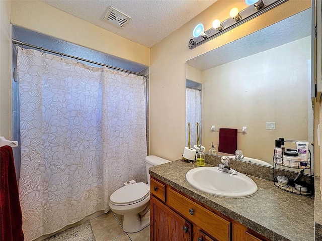 bathroom with visible vents, toilet, tile patterned floors, a textured ceiling, and vanity