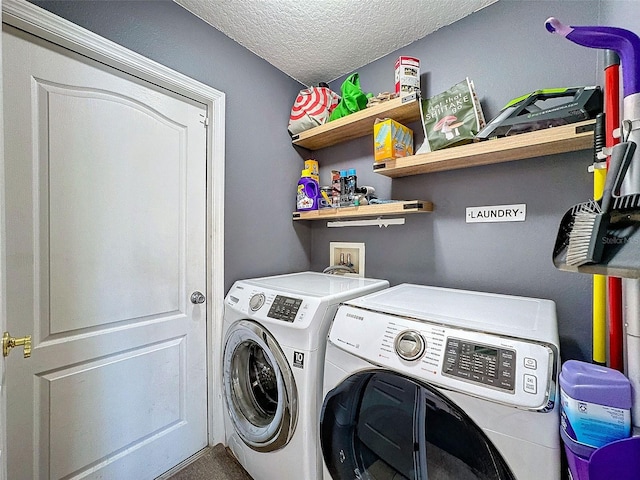 laundry area with laundry area, a textured ceiling, and separate washer and dryer