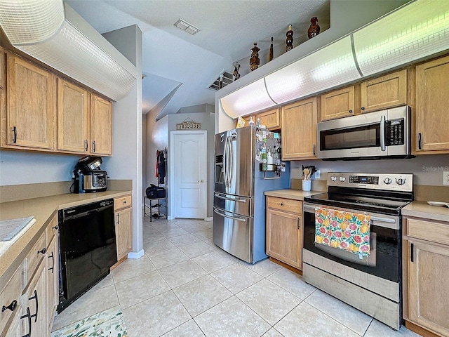 kitchen featuring appliances with stainless steel finishes, light countertops, visible vents, and light tile patterned flooring