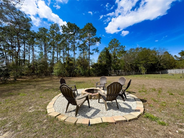 view of yard with a patio, a fire pit, and fence