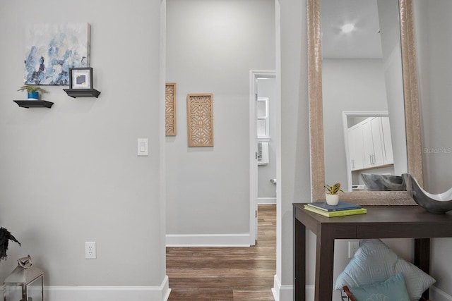 hallway with baseboards and wood finished floors