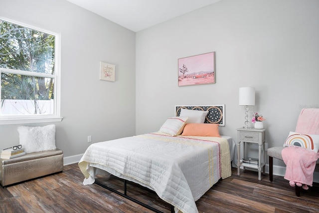 bedroom with baseboards and wood finished floors