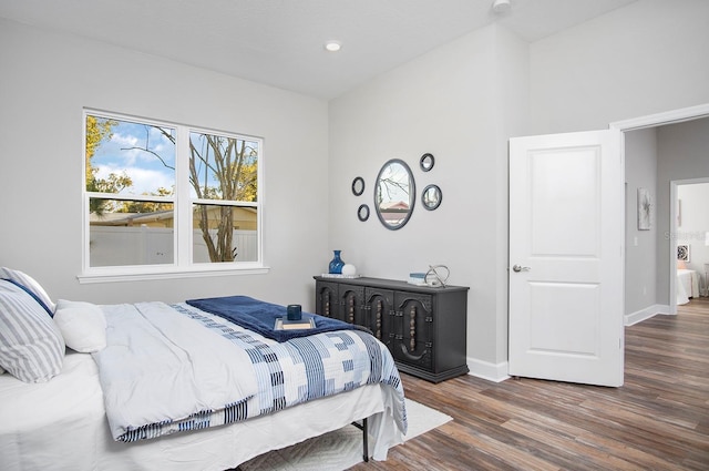 bedroom with wood finished floors and baseboards