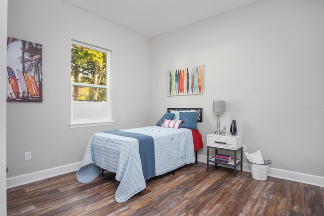 bedroom featuring baseboards and wood finished floors