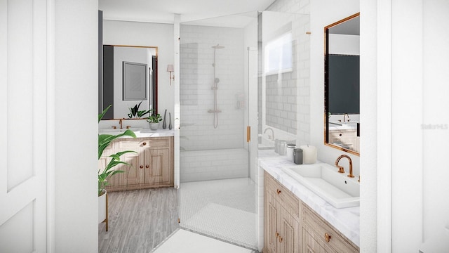 full bathroom featuring a stall shower, two vanities, and a sink