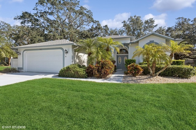 view of front of property with a garage, a front lawn, concrete driveway, and stucco siding