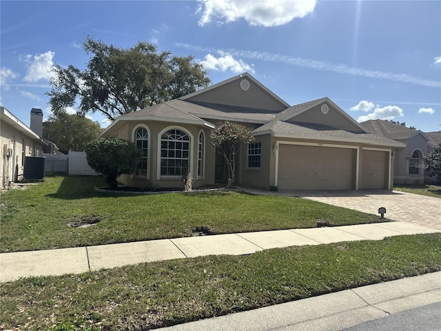 ranch-style house featuring stucco siding, a front yard, central AC, fence, and a garage