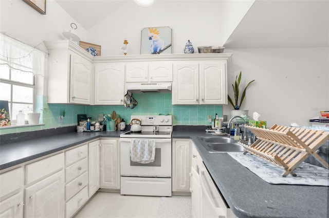 kitchen with dark countertops, white appliances, under cabinet range hood, and a sink