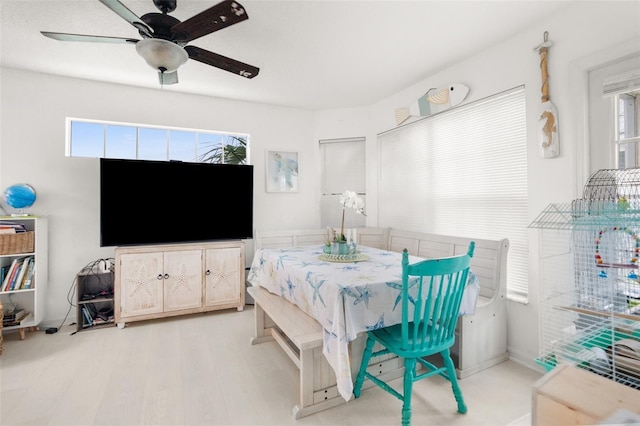 dining room featuring light wood-style floors and a ceiling fan