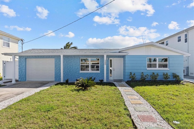 single story home featuring a front yard, roof with shingles, driveway, and an attached garage