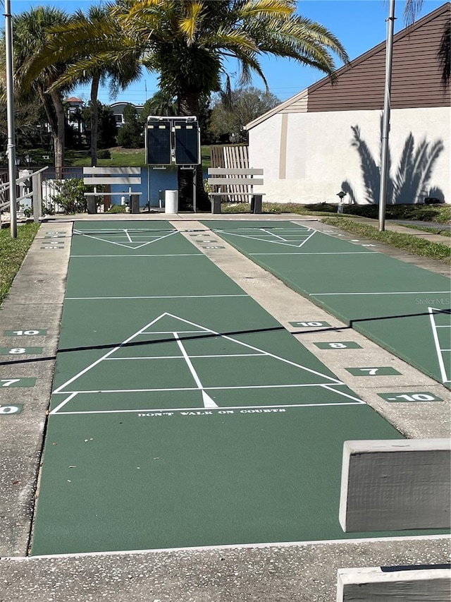 view of community featuring shuffleboard and fence