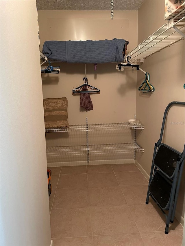 spacious closet featuring tile patterned flooring