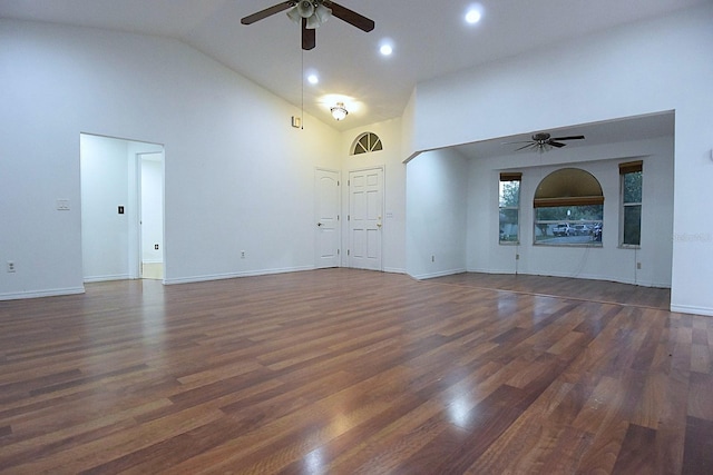 unfurnished living room with baseboards, ceiling fan, high vaulted ceiling, and wood finished floors