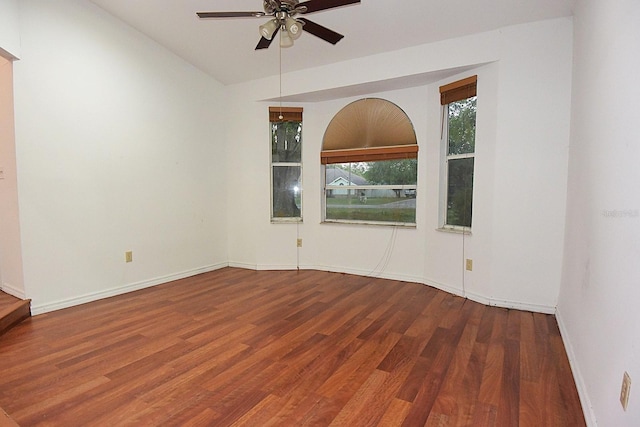 unfurnished room featuring ceiling fan, baseboards, and wood finished floors