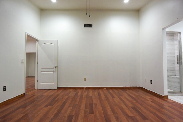 unfurnished room with recessed lighting, visible vents, and wood finished floors