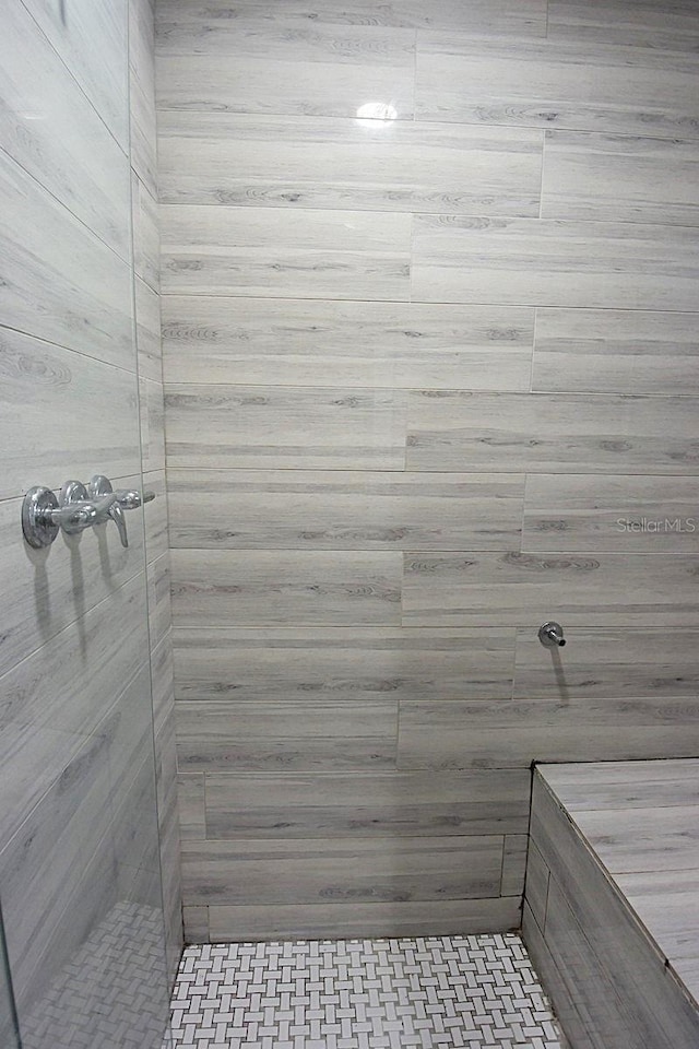 bathroom with tiled shower