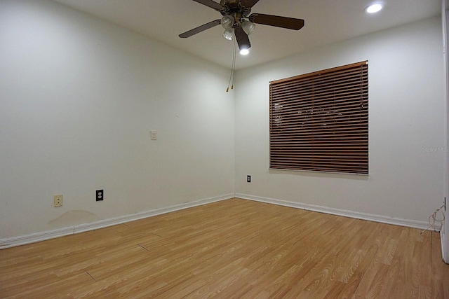 spare room with recessed lighting, light wood-type flooring, a ceiling fan, and baseboards