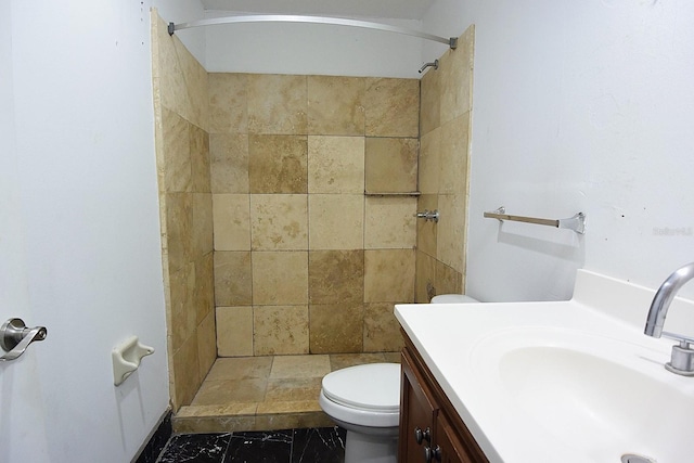 full bathroom with toilet, a stall shower, and vanity